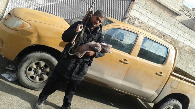 Dhar, a Hindu who converted to Islam, taunted British authorities after his arrival in Syria, posting a photo of himself on social media with his baby son in one arm and an AK-47 assault rifle in the other. (Photo: Twitter) Dhar, a Hindu who converted to Islam, taunted British authorities after his arrival in Syria, posting a photo of himself on social media with his baby son in one arm and an AK-47 assault rifle in the other. (Photo: Twitter)